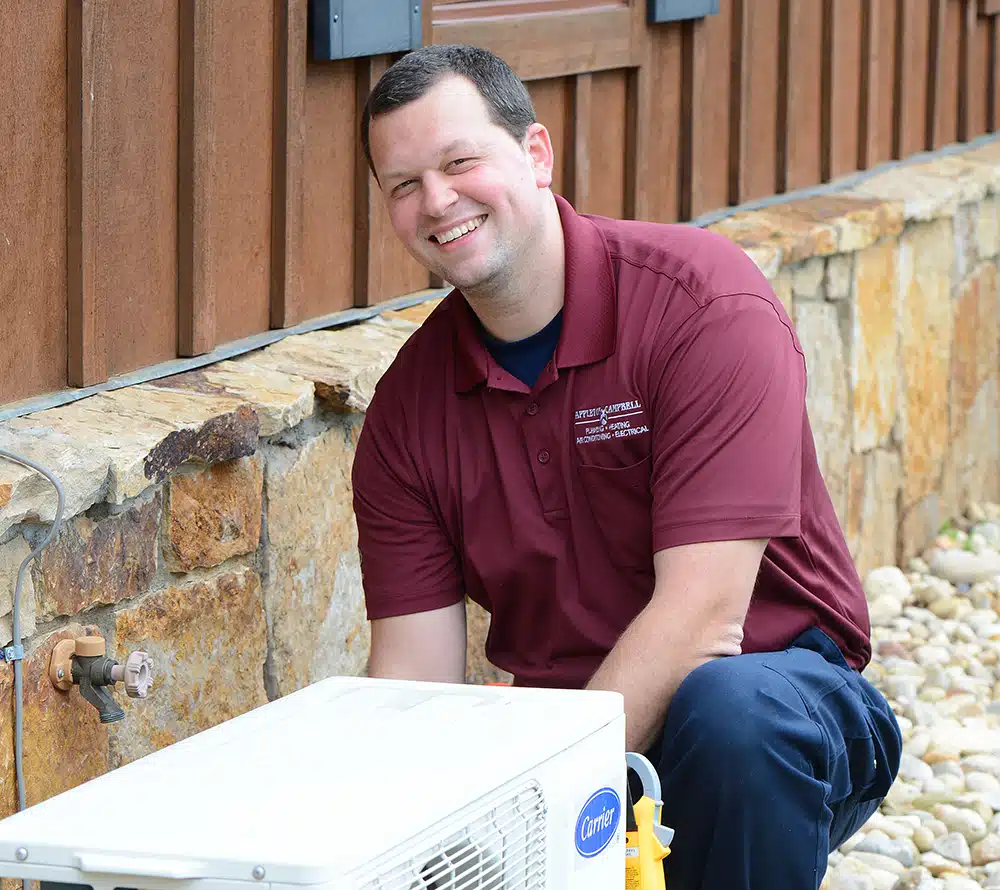 Electrician servicing outdoor mini split in Warrenton, VA.