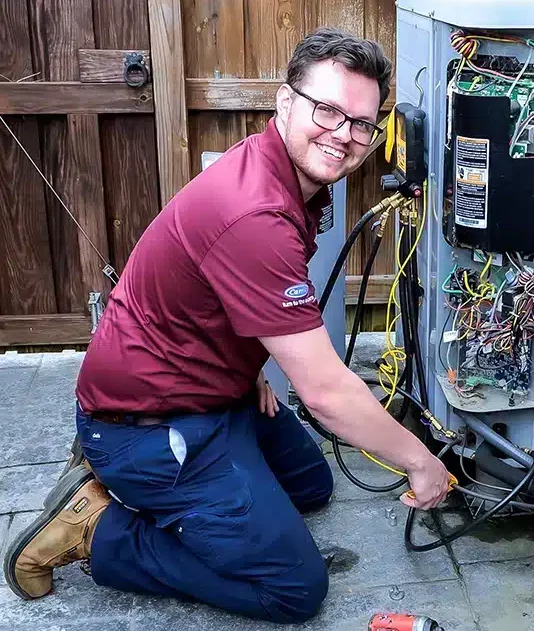 Appleton Campbell HVAC technician doing routine maintenance on an HVAC unit.