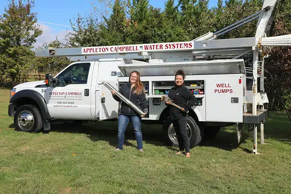 Katelynn and Melinda in front of the Appleton Campbell Well Pump Truck.
